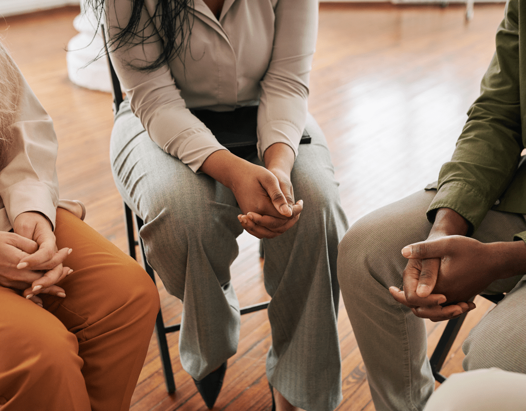 Narcotics anonymous attendees sitting in a circle.