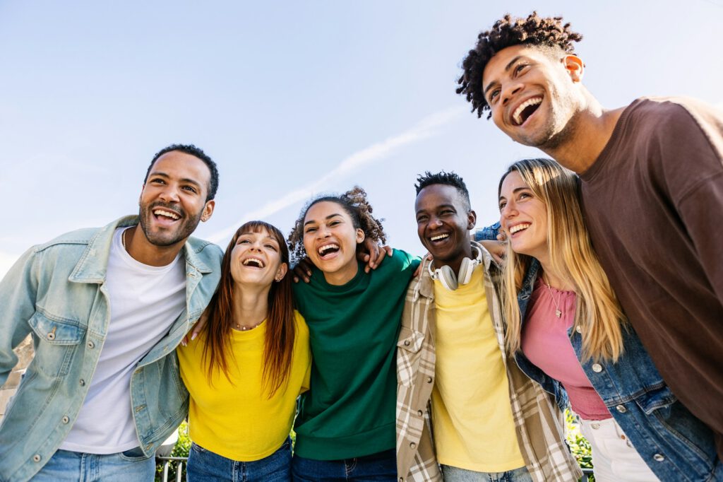 Young group of people having fun together outdoors in a sunny day while sober.